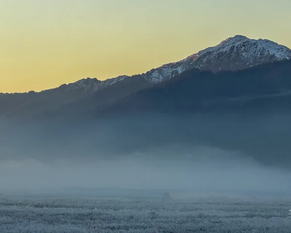 Mountain above a low layer of mist